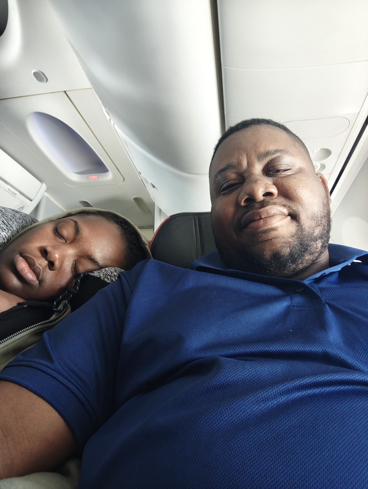 Desmarie asleep on Joanson's shoulder on a flight