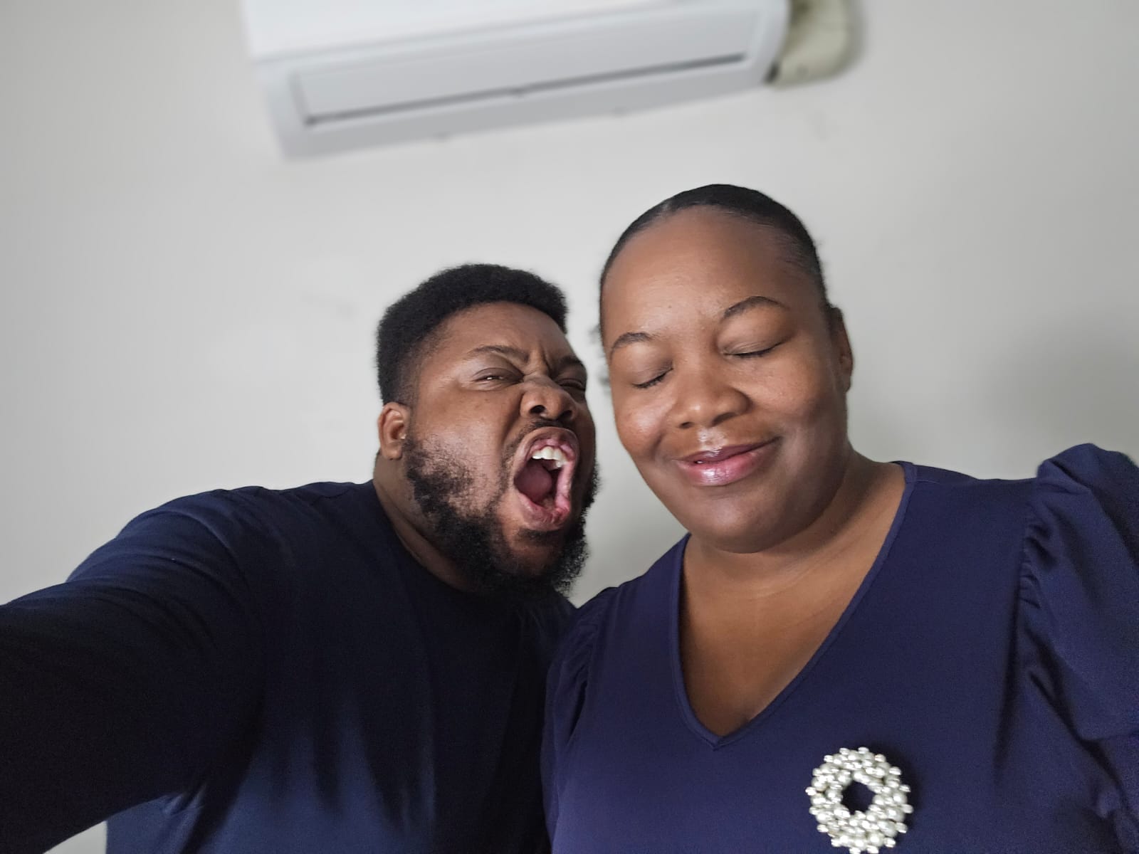 Desmarie and Joanson making silly faces in a close-up selfie