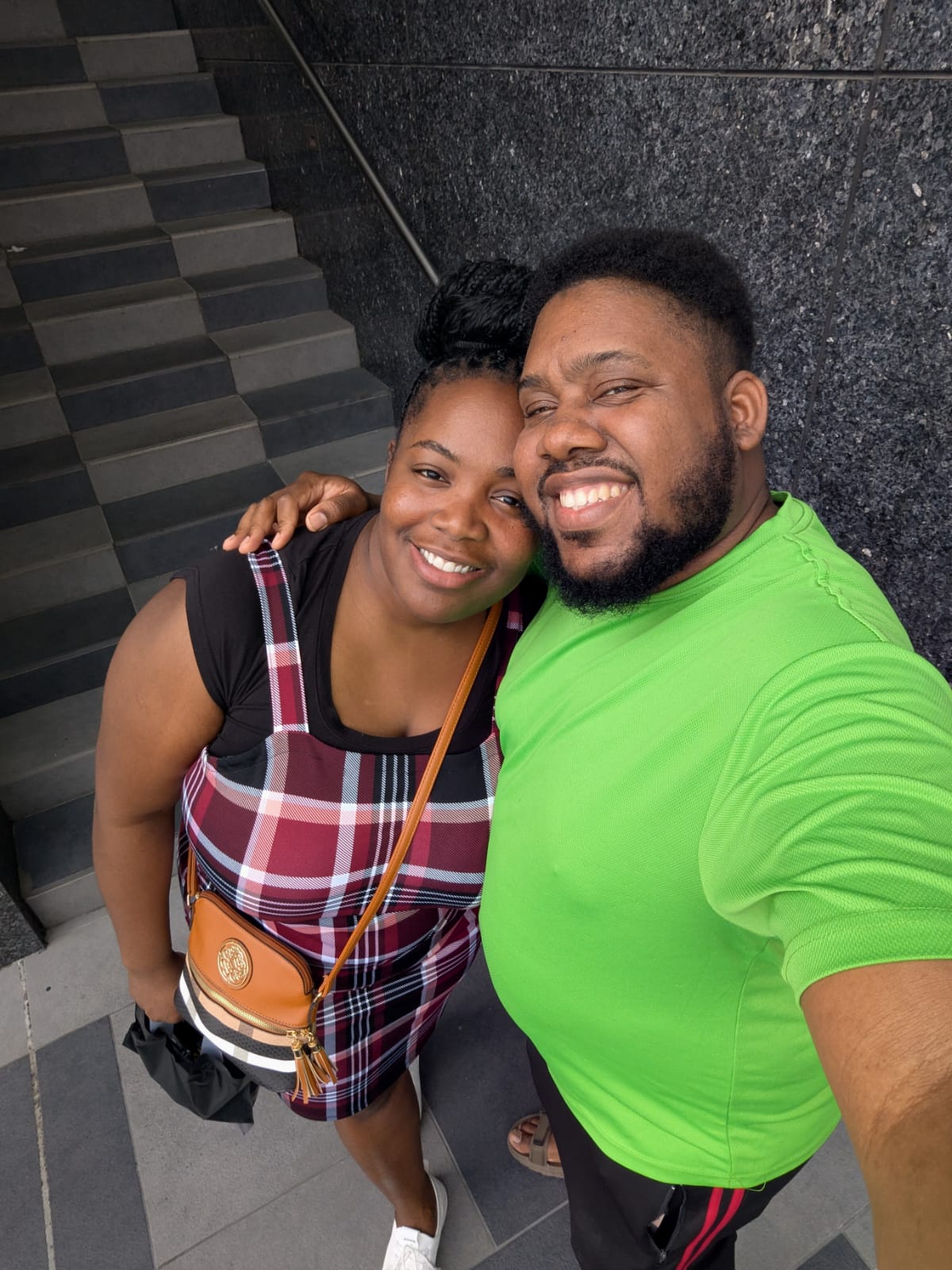 Desmarie and Joanson taking a selfie on a stairwell